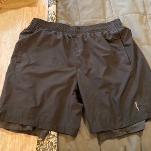 Black athletic shorts with spandex lining that’s full leg length